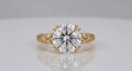 Direct top view of a brilliant 4 CT round lab grown diamond secured by double claw prongs with engraved shoulders.