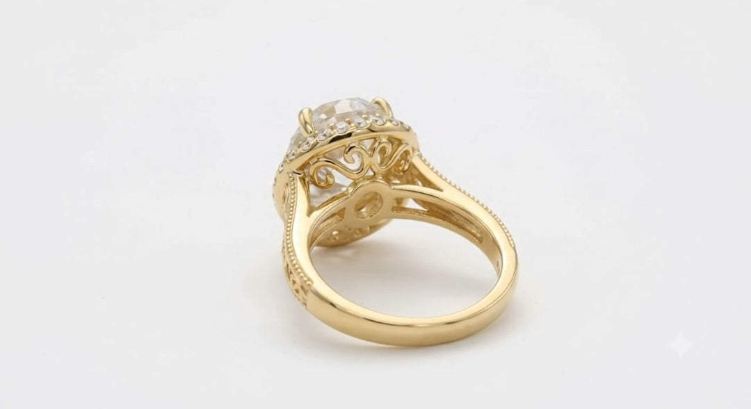 Underside view of a yellow gold vintage ring showing scrollwork filigree undergallery and polished inner shank.
