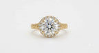 Direct top view of a 4 carat round brilliant lab diamond encased in a micro-pavé halo with milgrain-bordered engraved shoulders.