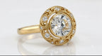 Angled side view of a 4 CT round lab grown diamond ring with a bezel setting and openwork filigree halo in yellow gold.