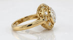 Side-angled view of a 4 carat round lab diamond vintage halo ring with smooth yellow gold band.