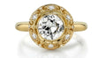 Top-down view of a 4 CT round cut lab grown diamond encased in a bezel setting with diamond-accented filigree halo.