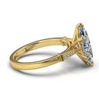 Angled side view of a 4 carat marquise lab grown diamond ring with yellow gold milgrain shank and pave side accents.