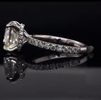 Side profile view of a 3 CT cushion cut lab grown diamond ring featuring a sparkling hidden diamond halo and a pave set band.
