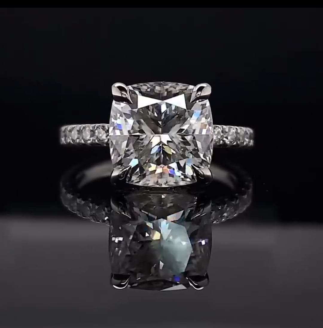 Direct top-down view of a breathtaking 3 CT cushion cut lab grown diamond engagement ring emphasizing its brilliant faceting and perfect symmetry.
