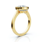 Angled side view of a yellow gold engagement ring featuring a 4 CT round lab diamond bezel setting with hidden diamond halo.