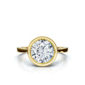 Top-down view of a 4 CT round cut lab grown diamond in a full bezel setting made of 14K yellow gold.