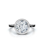 Overhead top view of a 4 CT round lab diamond framed in a sleek white gold bezel setting.