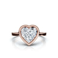 Overhead top-down view of a 4 CT heart cut lab grown diamond set in a sleek 14K rose gold bezel setting.