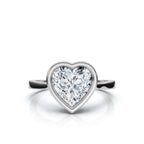 Top-down view of a 4 CT heart cut lab diamond framed in a high-polish white gold bezel setting.