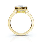 Direct side profile view of a yellow gold heart shaped lab diamond ring highlighting the cathedral arch and hidden halo collar.
