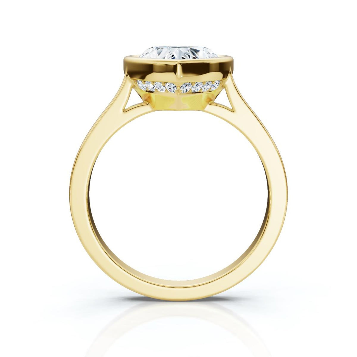 Direct side profile view of a yellow gold heart shaped lab diamond ring highlighting the cathedral arch and hidden halo collar.