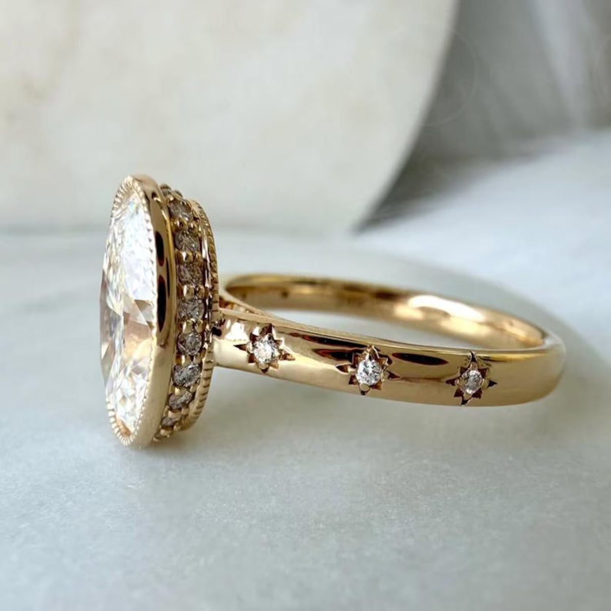 Side profile view of a yellow gold 5 CT oval diamond ring highlighting the hidden micro-pavé halo and starburst flush-set band.