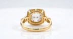 Undergallery bottom view of a 4 CT round lab grown diamond engagement ring in yellow gold showing the open basket frame and shoulder accents.