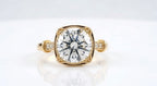 Top-down view of a 4 CT round cut lab diamond set inside a cushion-shaped milgrain frame with accent-set shoulders.