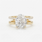 Front view of a 4 CT oval cut lab grown diamond engagement ring with a dual pavé and plain gold double band.