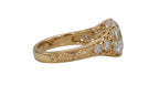 Side profile view of a 4 CT round lab grown diamond engagement ring in yellow gold with hand-engraved scrollwork and bezel-set shoulder accents.