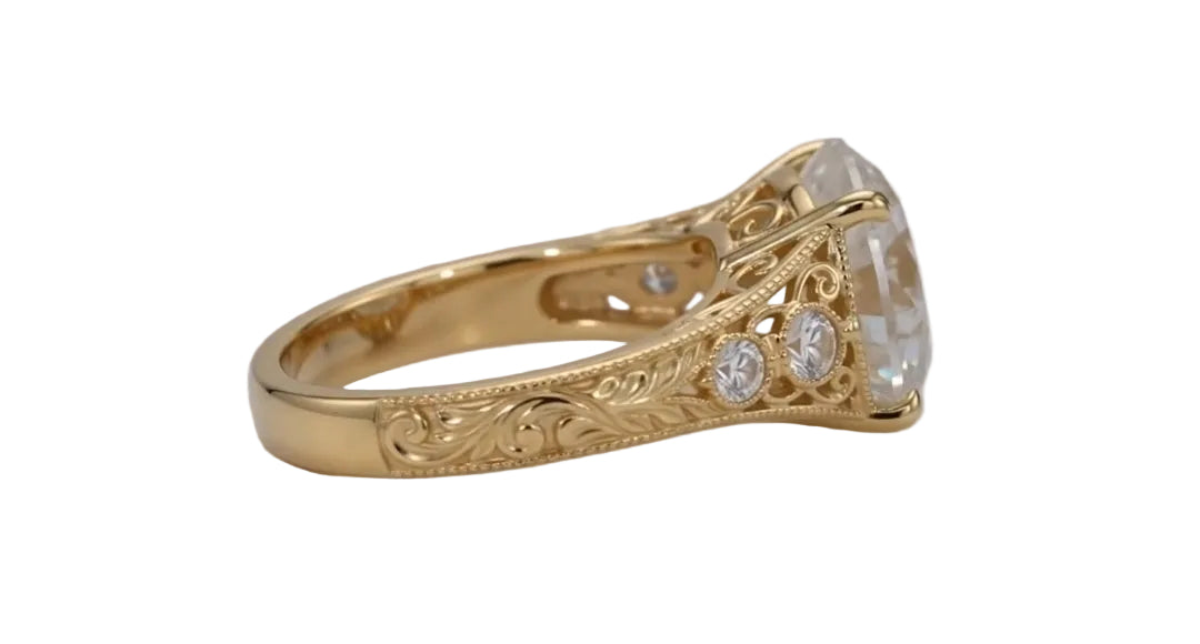 Side profile view of a 4 CT round lab grown diamond engagement ring in yellow gold with hand-engraved scrollwork and bezel-set shoulder accents.