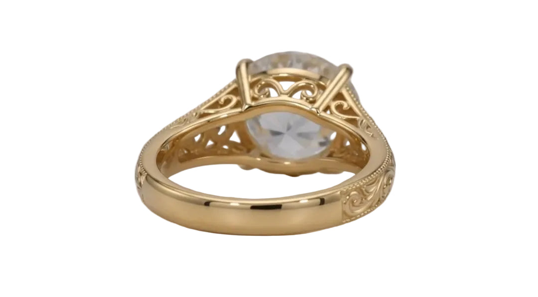 Rear view displaying the intricate scrollwork filigree open gallery basket of a 4 CT round lab diamond yellow gold ring.