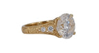 Angled side view of a 4 carat round cut lab diamond set in a vintage yellow gold ring with engraved leaf patterns.