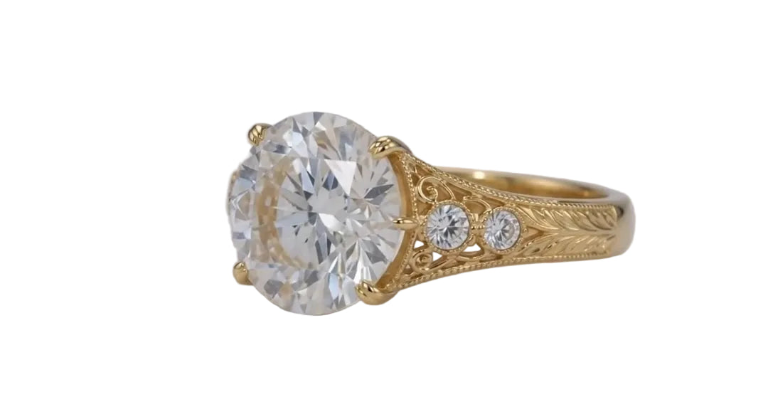 Side undergallery perspective showing high-polish yellow gold band transitioning to hand-engraved floral motifs.