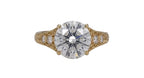 Top-down direct view of a 4 CT round brilliant cut lab grown diamond in a vintage hand-engraved yellow gold setting.