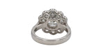 Undergallery perspective of a 2 CT round lab diamond ring showing the flower-shaped basket architecture.