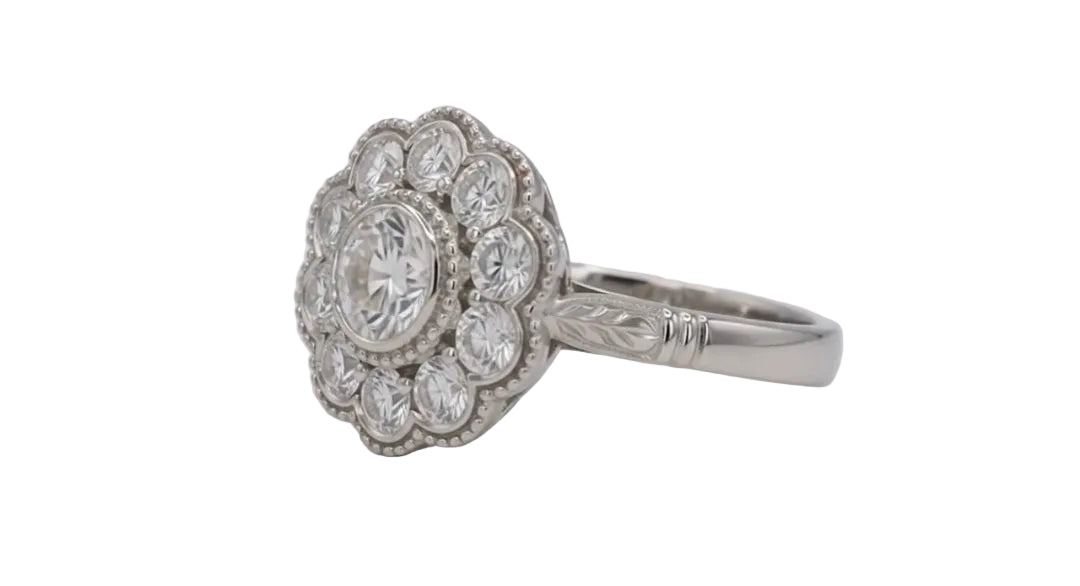 Three-quarter view of a 2 CT round lab diamond framed by a scalloped milgrain halo and leaf-engraved shank.