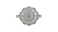 Top-down view of a 2 CT round cut lab diamond in a milgrain bezel surrounded by an eight-petal scalloped diamond halo.
