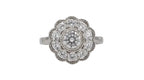 Top-down view of a 2 CT round cut lab diamond in a milgrain bezel surrounded by an eight-petal scalloped diamond halo.