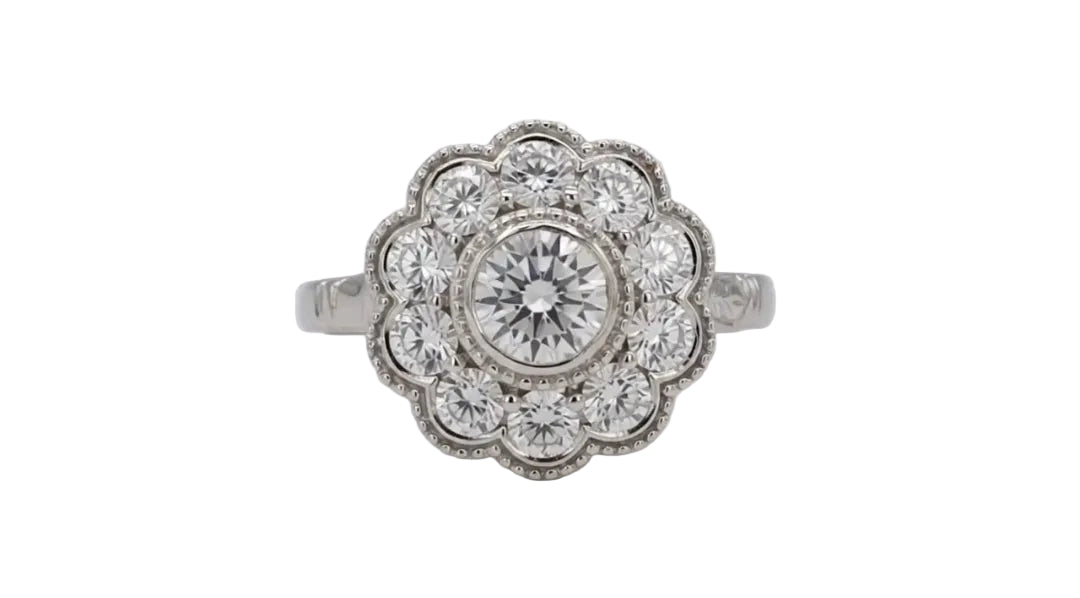 Top-down view of a 2 CT round cut lab diamond in a milgrain bezel surrounded by an eight-petal scalloped diamond halo.