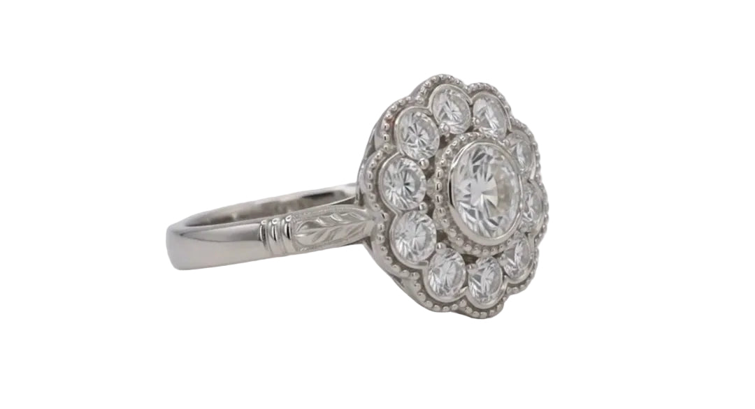 Angled perspective of a white gold 2 CT round lab diamond ring showing the floral bloom setting and hand-engraved band accents.