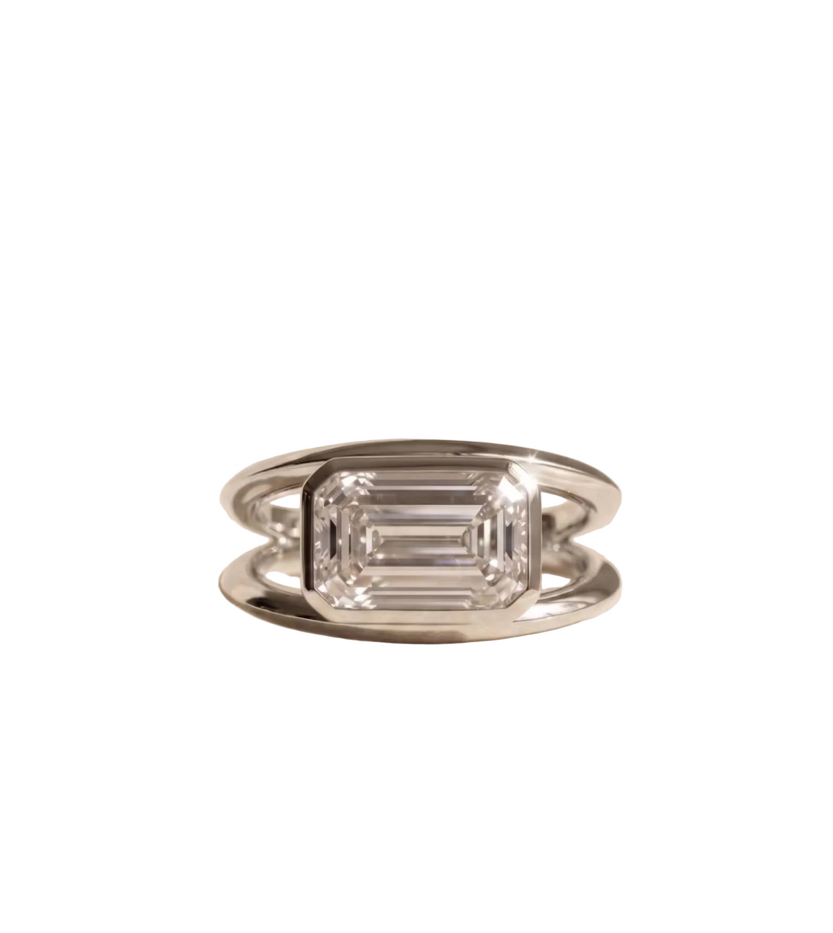 Direct view of a white gold modern engagement ring featuring a 3 carat horizontal emerald cut lab diamond in a sleek bezel frame.