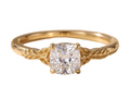 Direct face-up view of a 2 CT cushion cut lab grown diamond solitaire ring featuring sculpted botanical leaf shoulders in yellow gold.