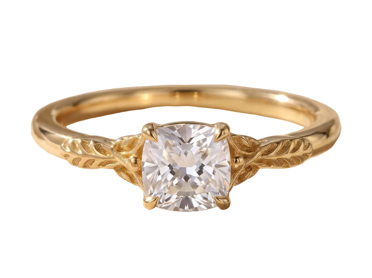 Direct face-up view of a 2 CT cushion cut lab grown diamond solitaire ring featuring sculpted botanical leaf shoulders in yellow gold.