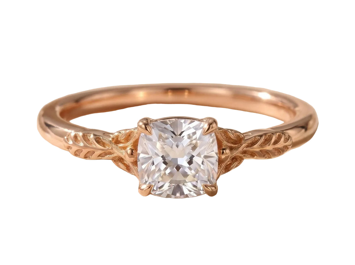 Front view of a 2 carat cushion cut lab diamond set in a rose gold vintage nature-inspired ring with carved leaf motifs.