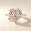 Frontal face-up view of a 2 CT pink heart cut lab grown diamond engagement ring surrounded by a sparkling double diamond halo.