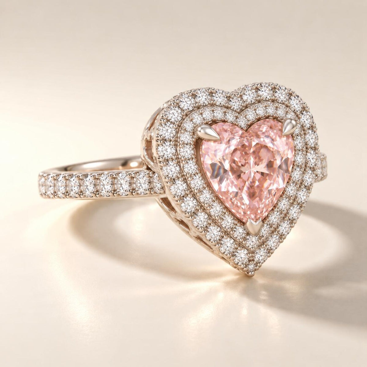 Angle view showcasing the double halo setting and pavé-set diamond band holding a 2 carat heart cut fancy pink lab diamond.