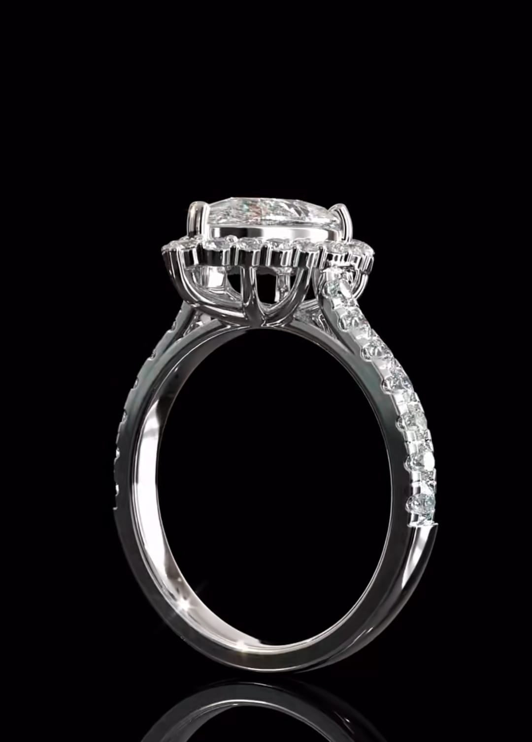 Side profile of a 3 CT pear cut lab grown diamond engagement ring highlighting the elevated crown basket setting and delicate pave band against a dark background.