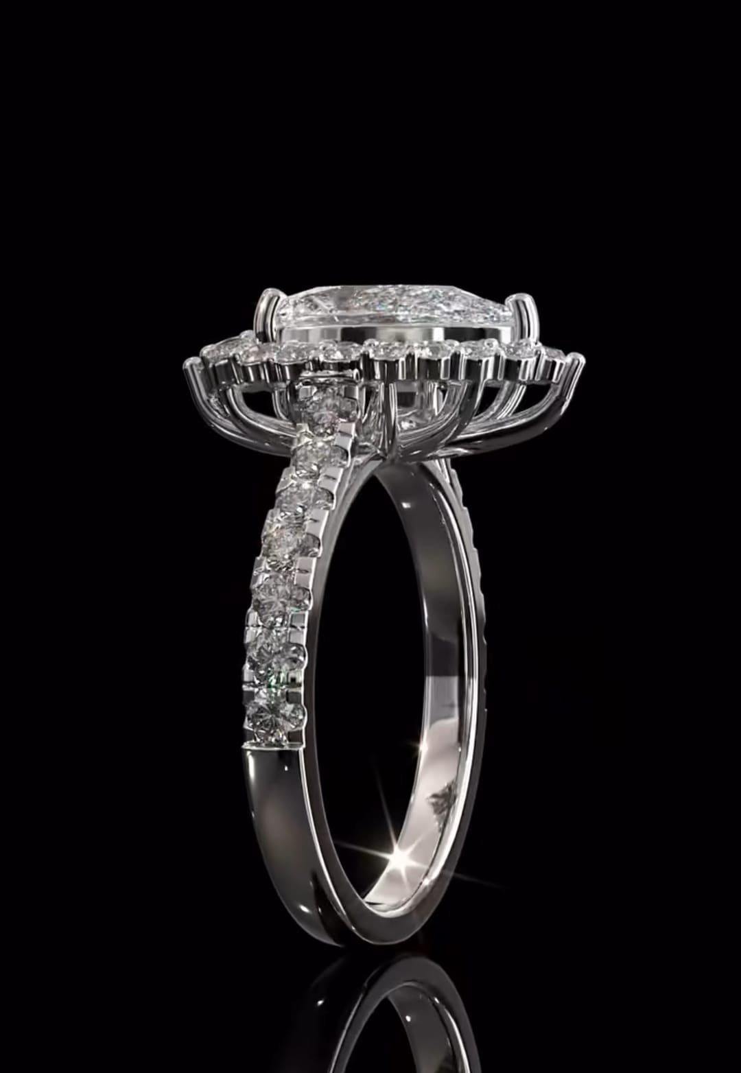 Angled side profile showing the structural raised gallery beneath the scalloped halo of a white gold pear cut diamond ring.