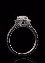 Direct side view of a pear cut diamond ring emphasizing the intricate, open-prong architectural basket design supporting the center stone.