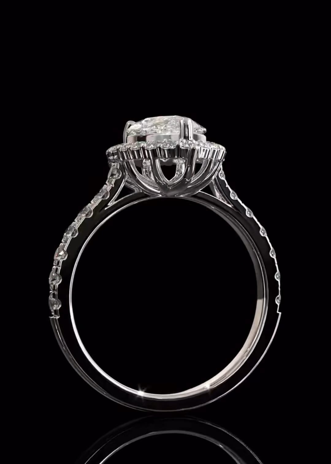 Direct side view of a pear cut diamond ring emphasizing the intricate, open-prong architectural basket design supporting the center stone.