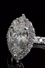 Stunning macro angled shot of a pear cut lab grown diamond highlighting the intense light reflection and side pave details.
