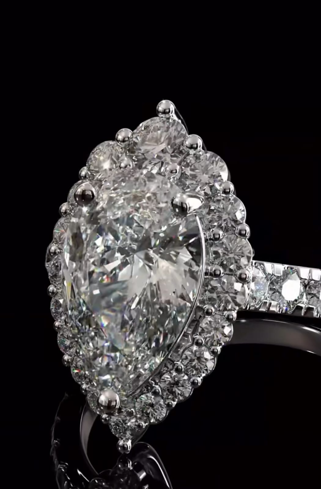 Stunning macro angled shot of a pear cut lab grown diamond highlighting the intense light reflection and side pave details.
