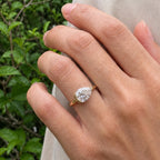 Close-up on hand showing a 2 carat horizontal pear cut lab diamond engagement ring in yellow gold.