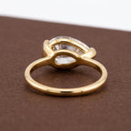 Rear structural perspective showing smooth gold band and open basket undergallery of a pear bezel ring.