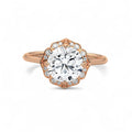 Top view of a 3 carat round lab grown diamond surrounded by a rose gold scalloped floral halo.