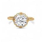 Face-up top view of a 3 CT round brilliant lab diamond in a yellow gold lotus petal halo.