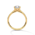 Direct side profile view of a yellow gold 4 CT emerald cut lab grown diamond engagement ring with open cathedral basket setting.