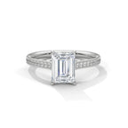 Direct top view of a white gold engagement ring featuring a 4 carat emerald cut lab grown diamond with pave accent band.